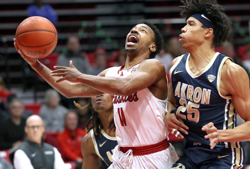 Northern Illinois' David Coit goes to the basket against Akron’s Enrique Freeman during their game Tuesday, Jan. 2, 2024, in the Convocation Center at NIU in DeKalb.