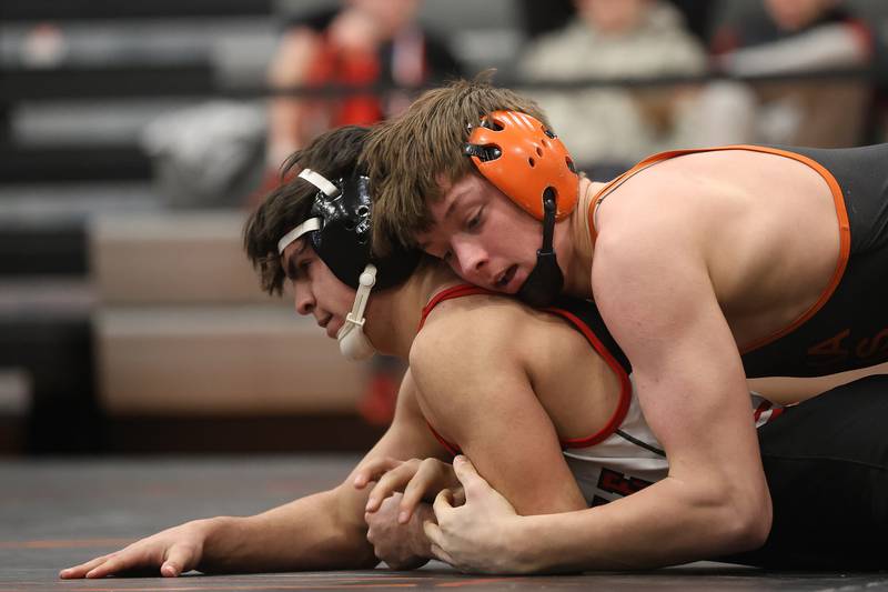 Minooka’s Mason Vogt works over Yorkville’s Donncha Souza in the SouthWest Prairie Conference 157 pound championship on Saturday, Jan. 24, 2026 in Minooka.