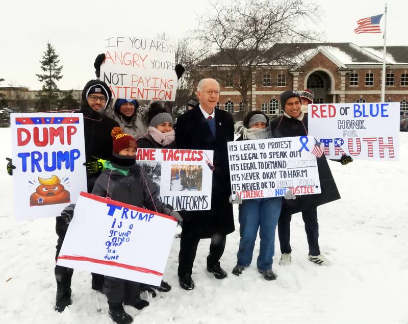 U.S. Rep. Bill Foster (center) poses with attendees at a rally in South Elgin on Sunday, Jan. 25, 2026, over a second fatal shooting of a protester in Minneapolis by federal immigration authorities.