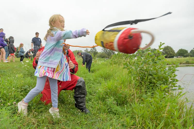 Eleanor Jaynes, 6 tosses the water rescue throw bag during the Campton Hills National Night Out on Tuesday, August 6, 2024.