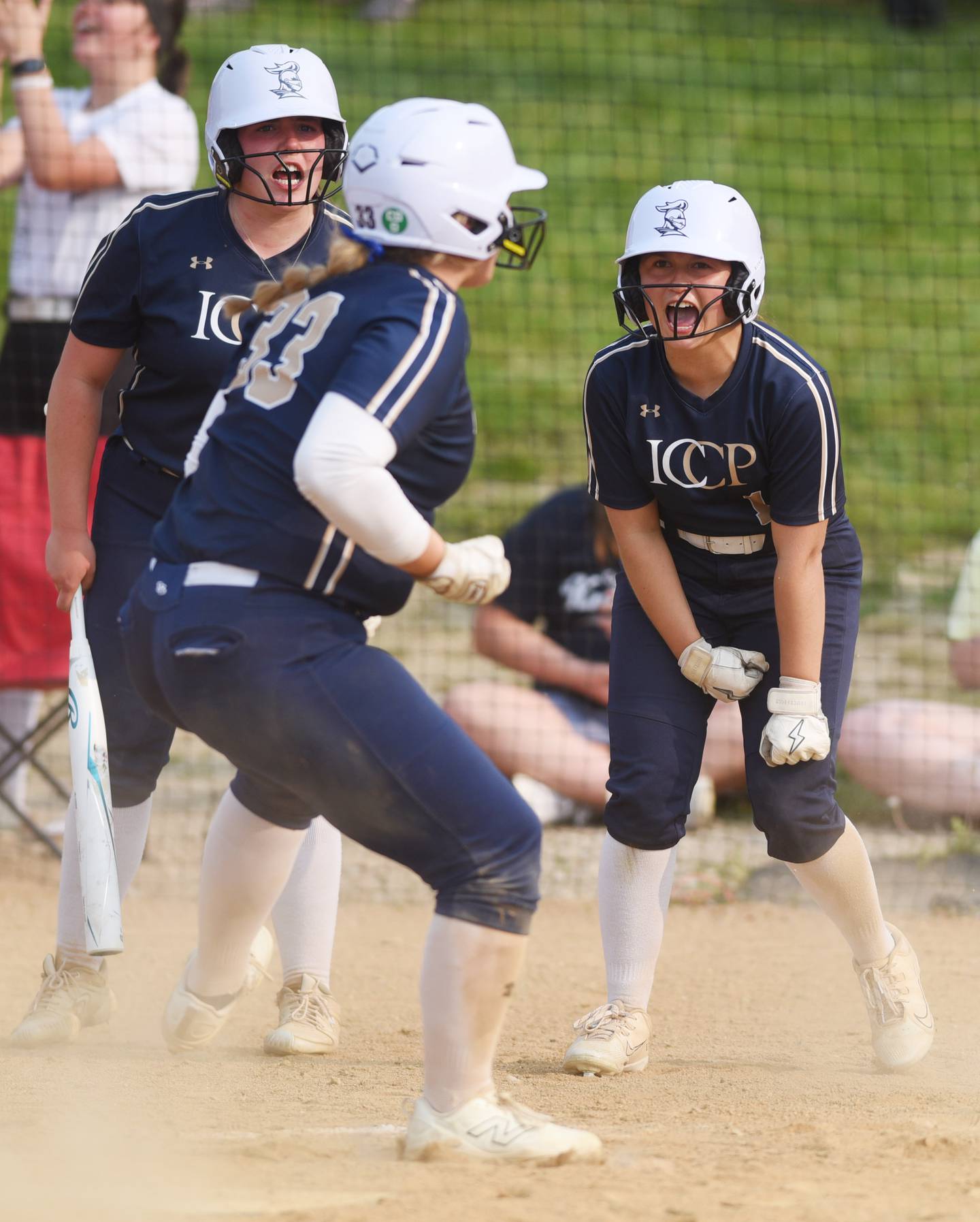 IC Catholic Prep’s Lexi Russ is greeted at the plate by Sofia Bucaro, right, who scored ahead of her, and on-deck hitter Sofia Bucaro following a sixth-inning double by Kelly Cahill during the Class 2A Benedictine University softball supersectional on Monday, June 2, 2025 in Lisle.