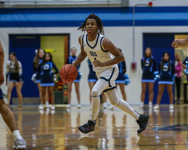 Downers Grove South's Keon Maggitt (1) looks over the defense during basketball game between Leyden at Downers Grove South. Feb 9, 2024.