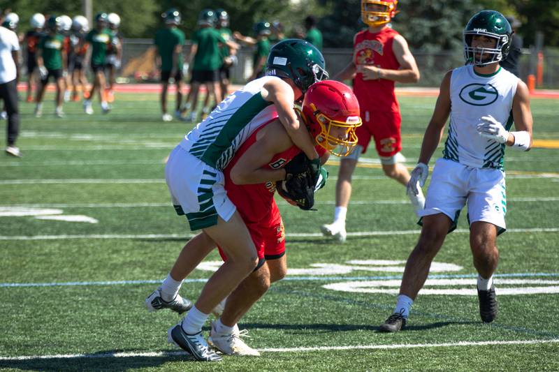 Luke Alwin gets caught up in Glenbard West's defense at Batavia High School's 7 on 7 tournament on Thursday, July 14, 2022.