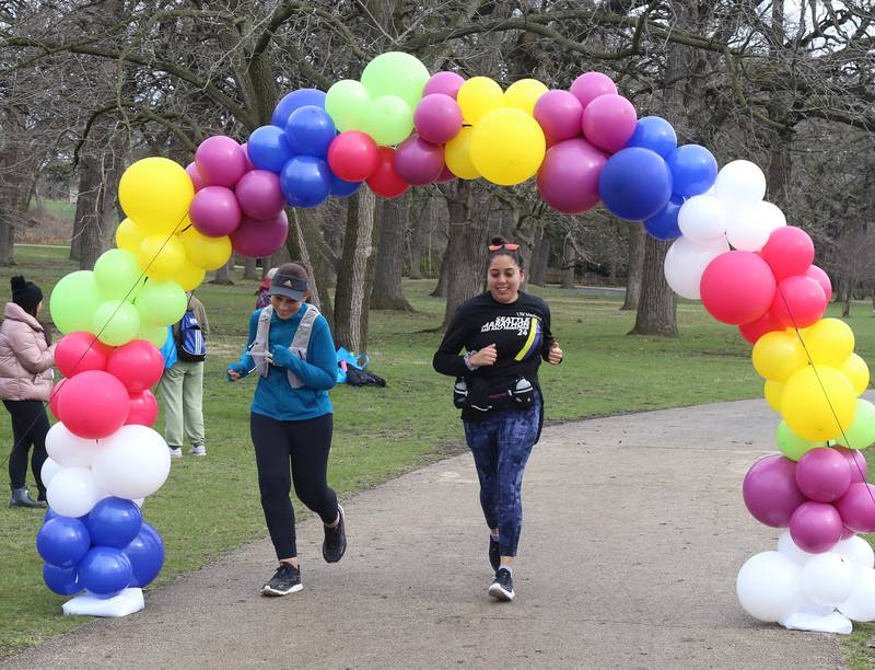 Evelyn Mix and Ruby Iberra crosses the finish line at the Color Outside the Line 5K that was held in Geneva on April 5, 2025.