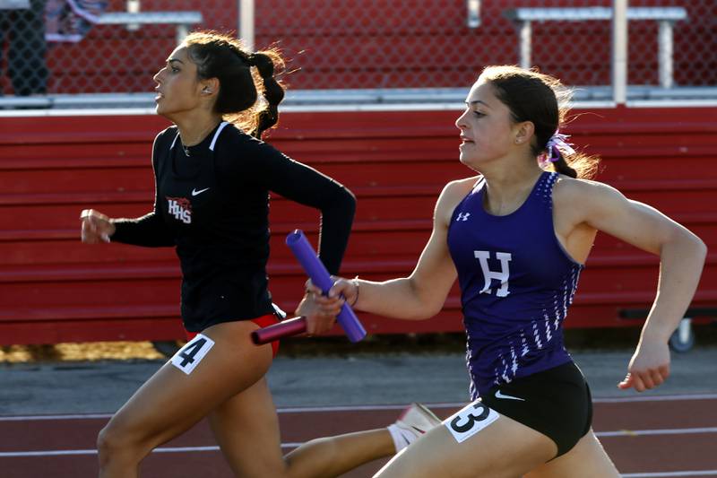 Huntley’s Ava Acevedo and Hampshire’s Kassidy Papa race neck and neck to the finish line as the race in the 4-200 meter relay on Thursday, May 8, 2025, during the Fox Valley Conference Girls Track and Field Meet at Huntley High School.