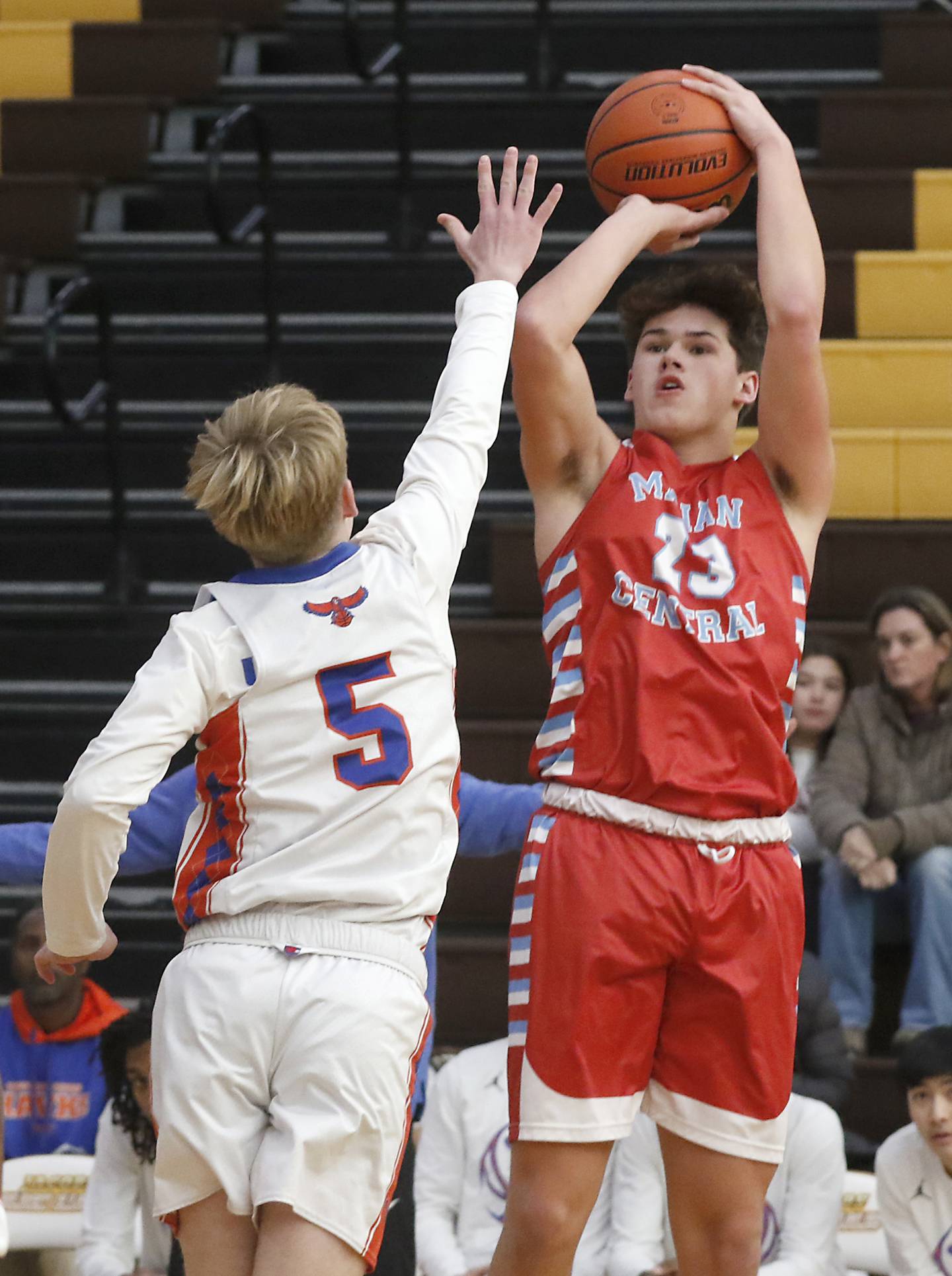 Marian Central's Cale McThenia shoots the ball over Hoffman Estates’ Connor Kurzynski during a Hinkle Holiday Classic basketball game Tuesday, Dec. 27, 2022, at Jacobs High School in Algonquin.