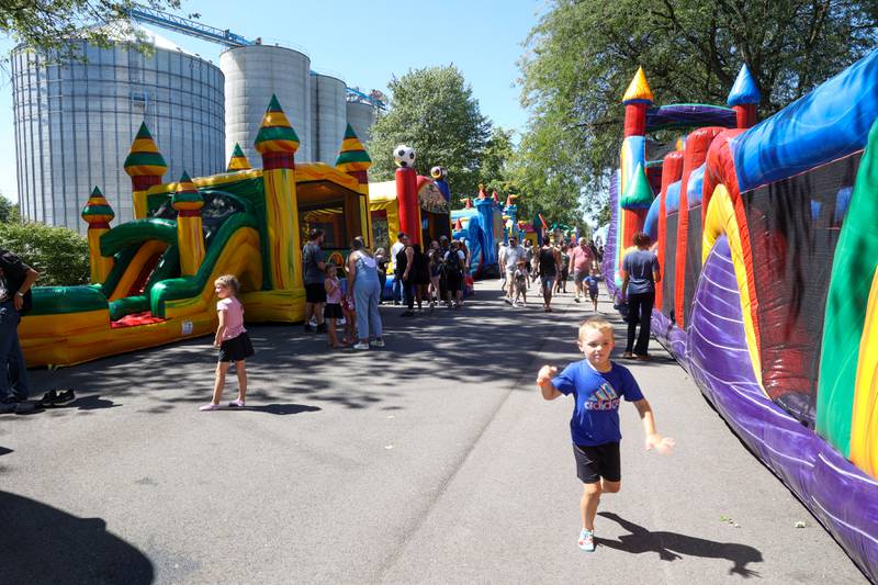 Children play in the inflatables adjacent to the Alliance Grain bins during the 104th annual Herscher Labor Day Celebration on Monday, Sept. 1, 2025.