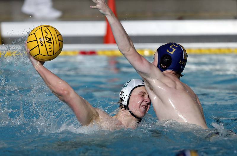 YorkÕs Gavin Honken (12) shoots around Lyons' Sean Gripp (5) during the IHSA State Water Polo consolation match Saturday May 20, 2023 at Stevenson High School in Lincolnshire.