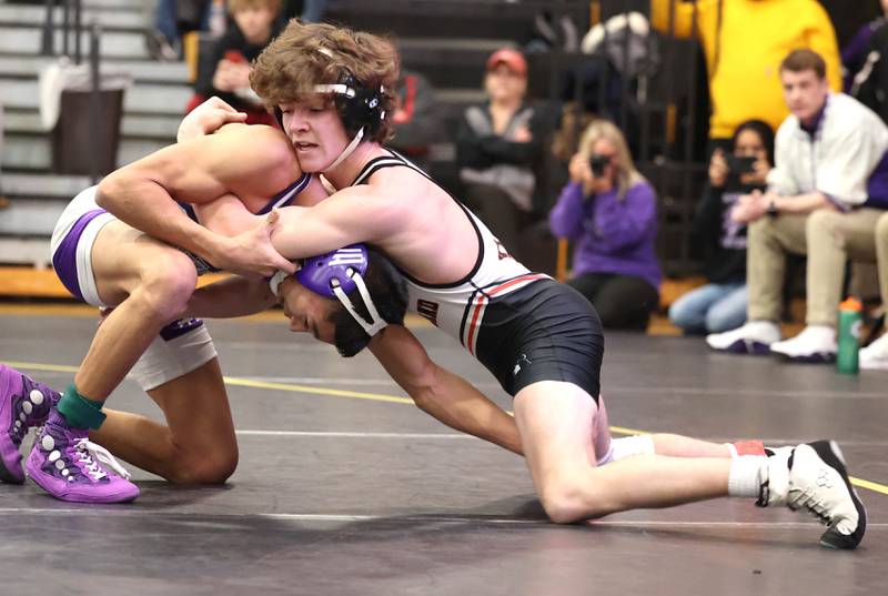 Kaneland’s Kamron Scholl tries to turn Rochelle’s Xavier Villalobos in their 120 pound match Saturday Jan. 21, 2023, during the Interstate 8 Conference wrestling tournament at Sycamore High School.