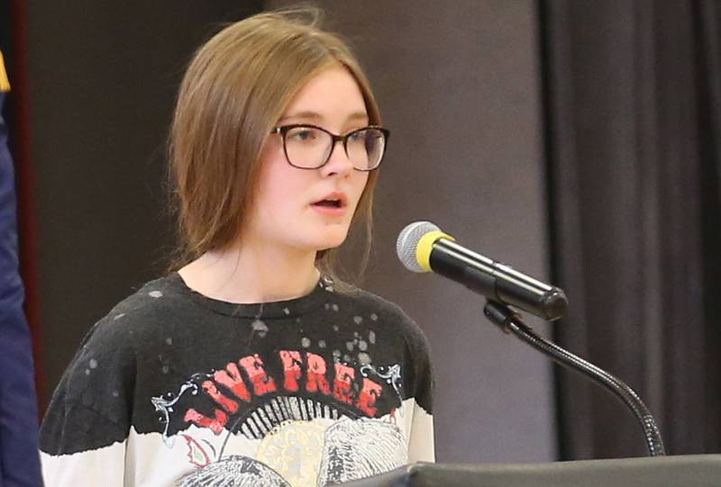 Parkside student Reagan Rahberg, reads her poem "Honor Those Who Served" during the annual Veterans Day Program on Monday, Nov. 11, 2024 at Parkside Middle School in Peru.