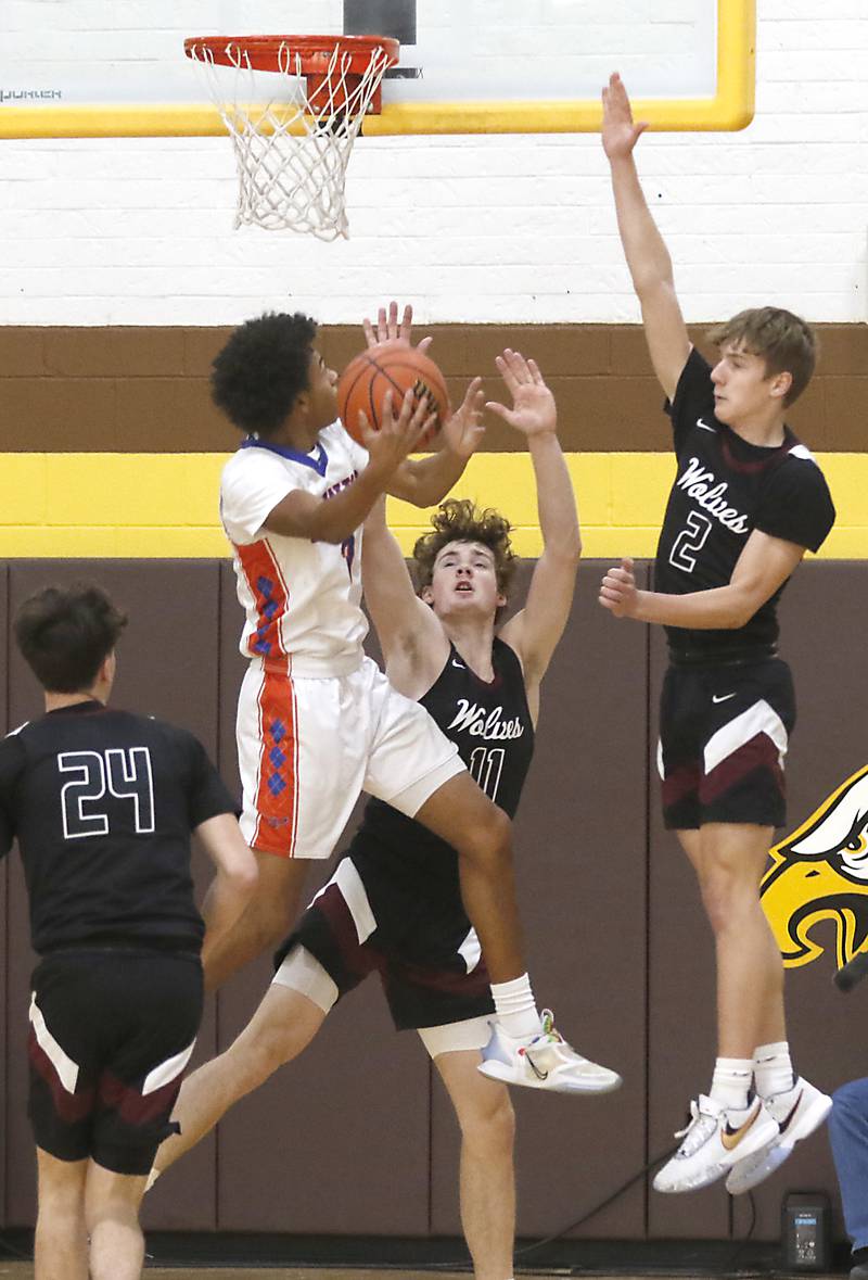 Hoffman Estates’ Trendell Whitting shoots the ball as Prairie Ridge's James Muse and Tomasiewicz defend during a Hinkle Holiday Classic basketball game Wednesday, Dec. 28, 2022, at Jacobs High School in Algonquin.