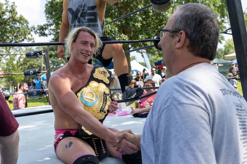(left to right) Heavyweight Champion Connor Hopkins shakes hand of Peru Mayor Ken Kolowski at the Taste of the Illinois Valley DreamWave Wrestling event on Saturday, August 2, 2025 at Centennial Park in Peru.