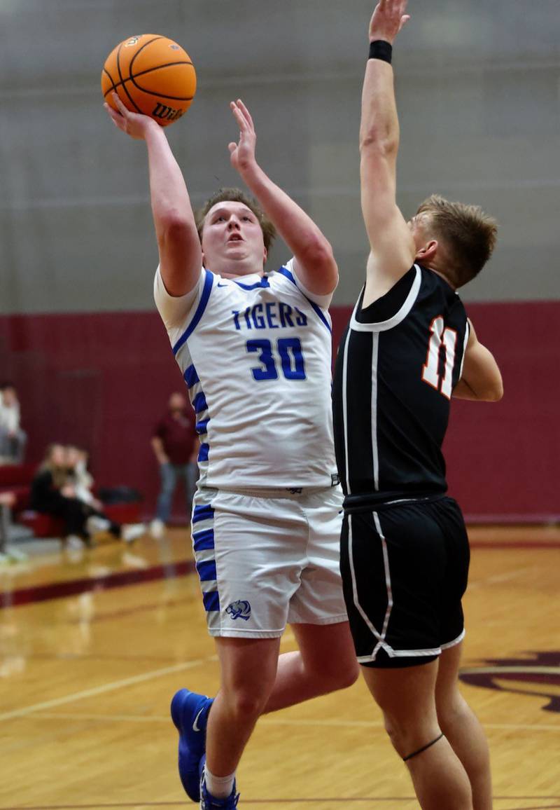 Princeton's Jordan Reinhardt shoots over  Byron's Cason Newton in Wednesday's sectional semifinals at Marengo. Princeton won 46-42 to advance to Friday's championship against Rock Falls.