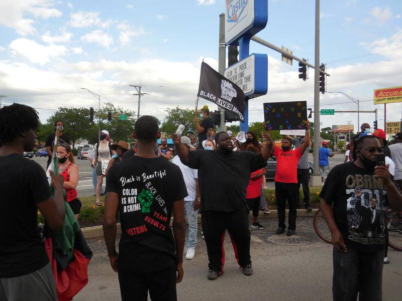 Demonstrators, including Stringer Harris (center), protested the death of Eric Lurry at the corner of Larkin Avenue and Jefferson Street.