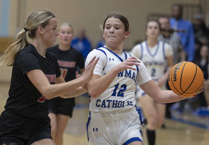 Newman’s Lucy Oetting handles the ball against Erie-Prophetstown’s Aubrey Housman Thursday, Dec. 12, 2024, at Newman High School.