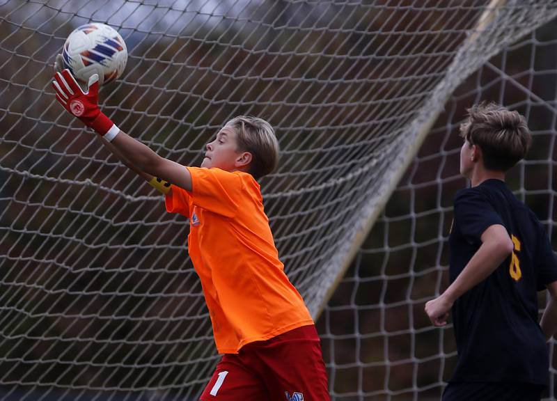 Marian Central's Dustin Emmert makes a save in front of Richmond-Burton's Brayden Mumbower during the IHSA Class 1A Marian Central Regional Boys Soccer Final match on Tuesday, Oct. 22, 2024, at Marian Central High School in Woodstock.