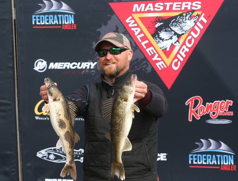 Michael Martin of Serena holds his walleye fish after weighing them in during the annual Masters Walleye Circuit tournament on Friday, March 21, 2025 at the Spring Valley Boat Club.