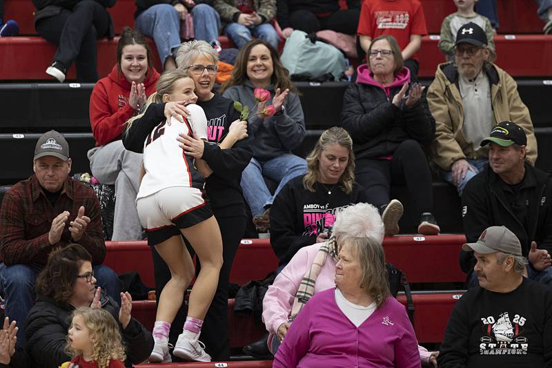 Amboy player Madison Althaus gets a hug after presenting a flower to a cancer survivor Tuesday, Jan. 27, 2026, in Amboy.