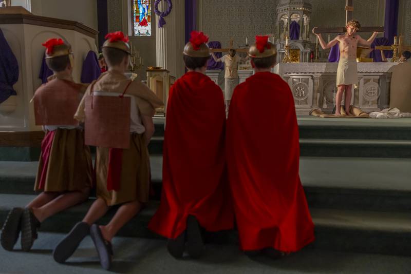Guards look on as Jesus, portrayed by Bruno Baker is hung on the cross during the Stations of The Cross event on April 16, 2025 at St. Patrick's Church.