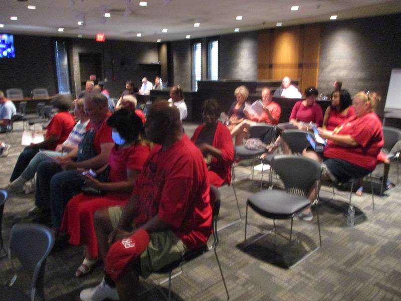 Residents dressed in red shirts to show unity in concerns about the VM Land quarry in Joliet gather before the start of the Joliet City Council meeting on Monday, July 17, 2023.