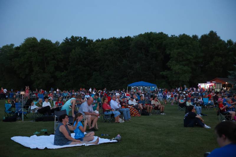 Attendees listen to live music by the Kankakee Valley Symphony Orchestra ahead of the city of Kankakee's fireworks show at Kankakee Community College on Friday, July 4, 2025.