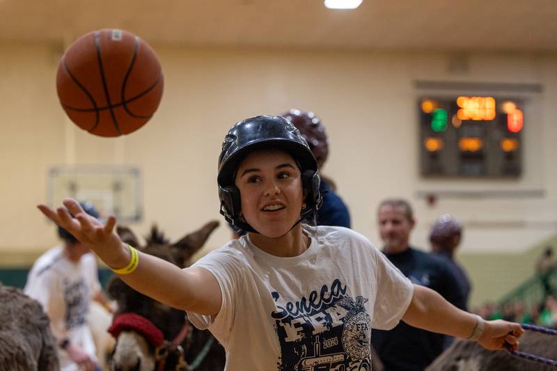 Member of 'Seneca FFA Officers and Alumni' reaches for rebound in game of Donkey Basketball on Saturday, Feb. 7, 2026 at Seneca High School West Campus in Seneca.