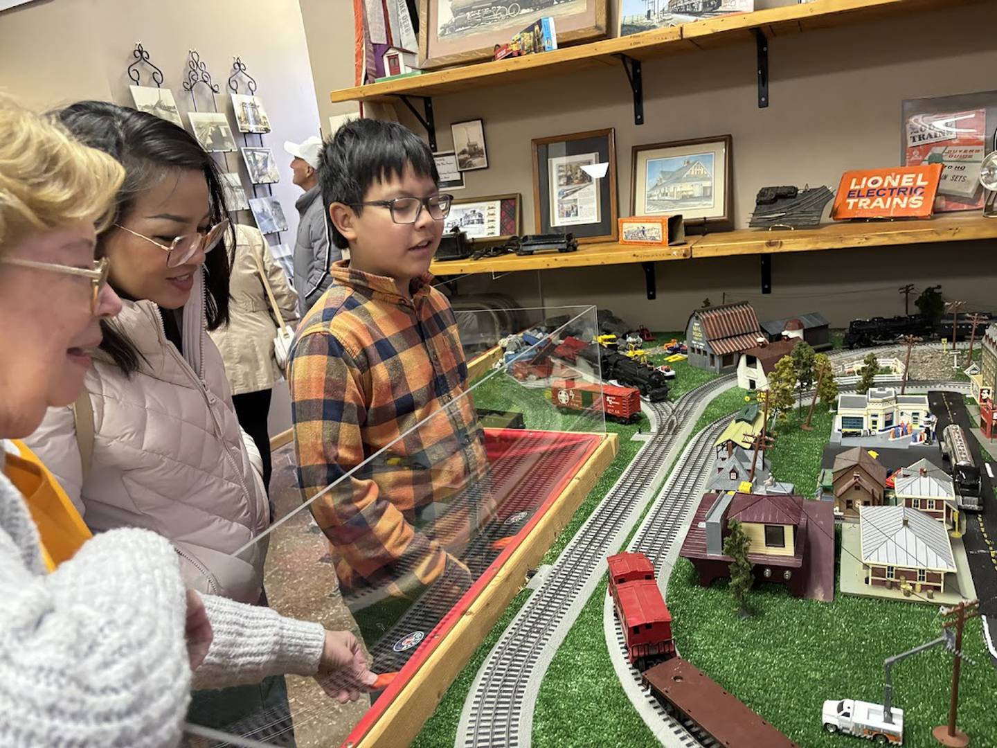 Museum goers watch the model trains Sunday, April 7, 2024, Seattle Sutton Marseilles Museum.