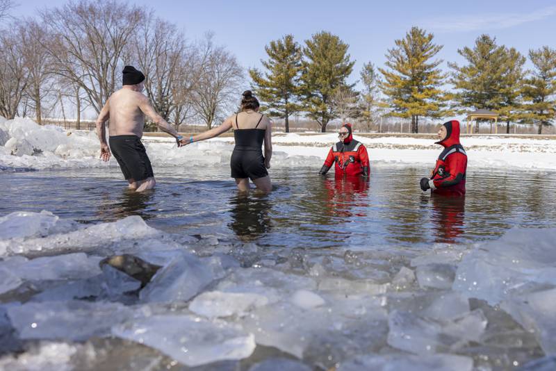 The first plunge team of the day gets in the frigid lake during the Polar Plunge for Special Olympics on February 22, 2025 at Lake Mendota.