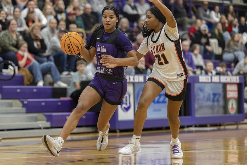 Dixon's Ahmyrie McGowan brings the ball up-court against Byron’s Malia Morton Friday, Dec. 27, 2024, during the Dixon Girls KSB Holiday Basketball Classic.