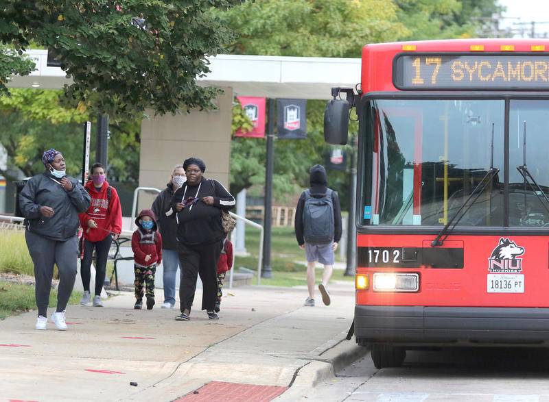 File photo: Riders catch the bus in September 2020 on Normal Road near the Holmes Student Center at Northern Illinois University.