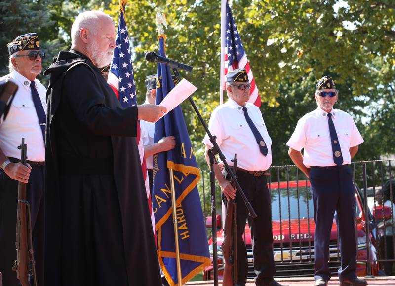 Father Ronald Margherio speaks during a 9/11 memorial ceremony on Thursday, Sept. 11, 2025 at the Veterans Park in Ladd.