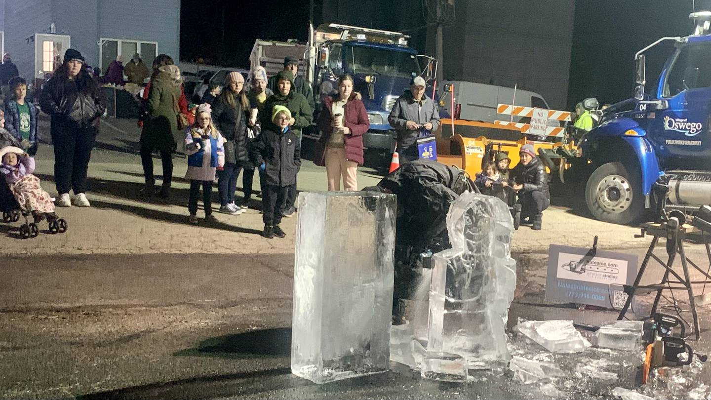 Sculptors carved Disney characters out of blocks of ice in front of spectators at the annual Christmas walk in downtown Oswego, Friday, Dec. 2 2022.