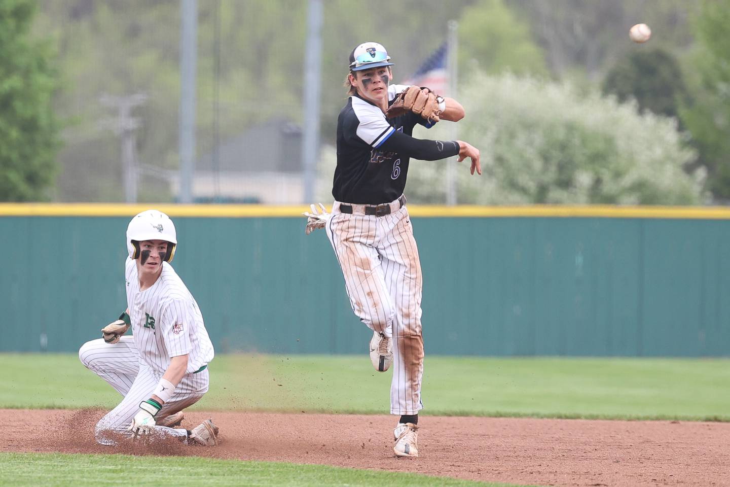 Lincoln-Way East’s Tyler Bell makes a throw to first to complete the double play to end the inning against Providence on Saturday, May 6, 2023, in New Lenox.