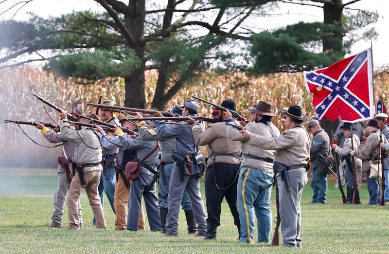 Confederate soldiers fire fake muscats Civil War reenactment during the Shadows of the Blue and Gray event on Sunday, Oct. 13, 2024 at City County Park in Princeton.