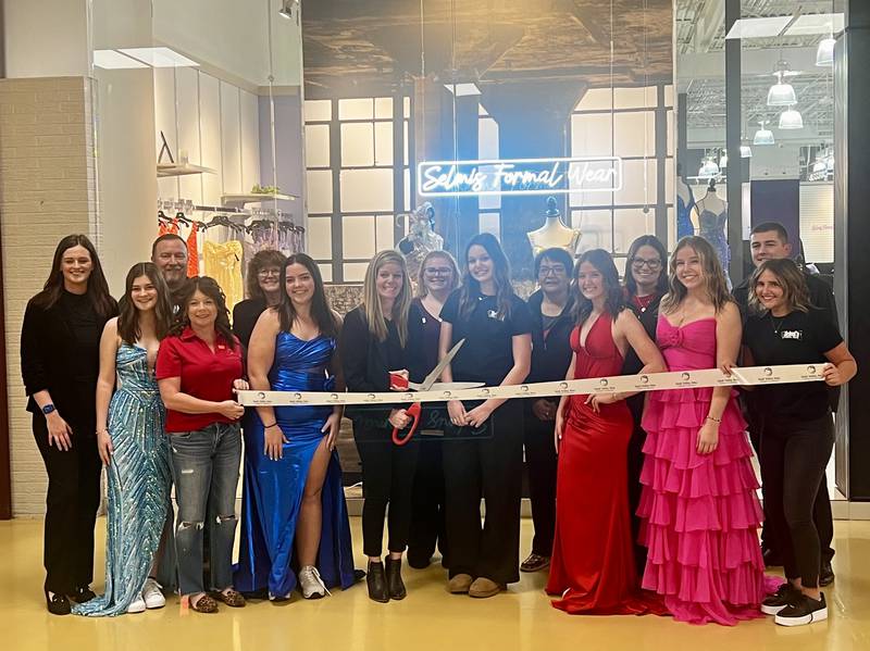 Katy Selmi stands ready with family and friends for the ribbon-cutting of her new business, Selmi's Formal Wear, inside Sterling's Northland Mall on Friday, Dec. 13.