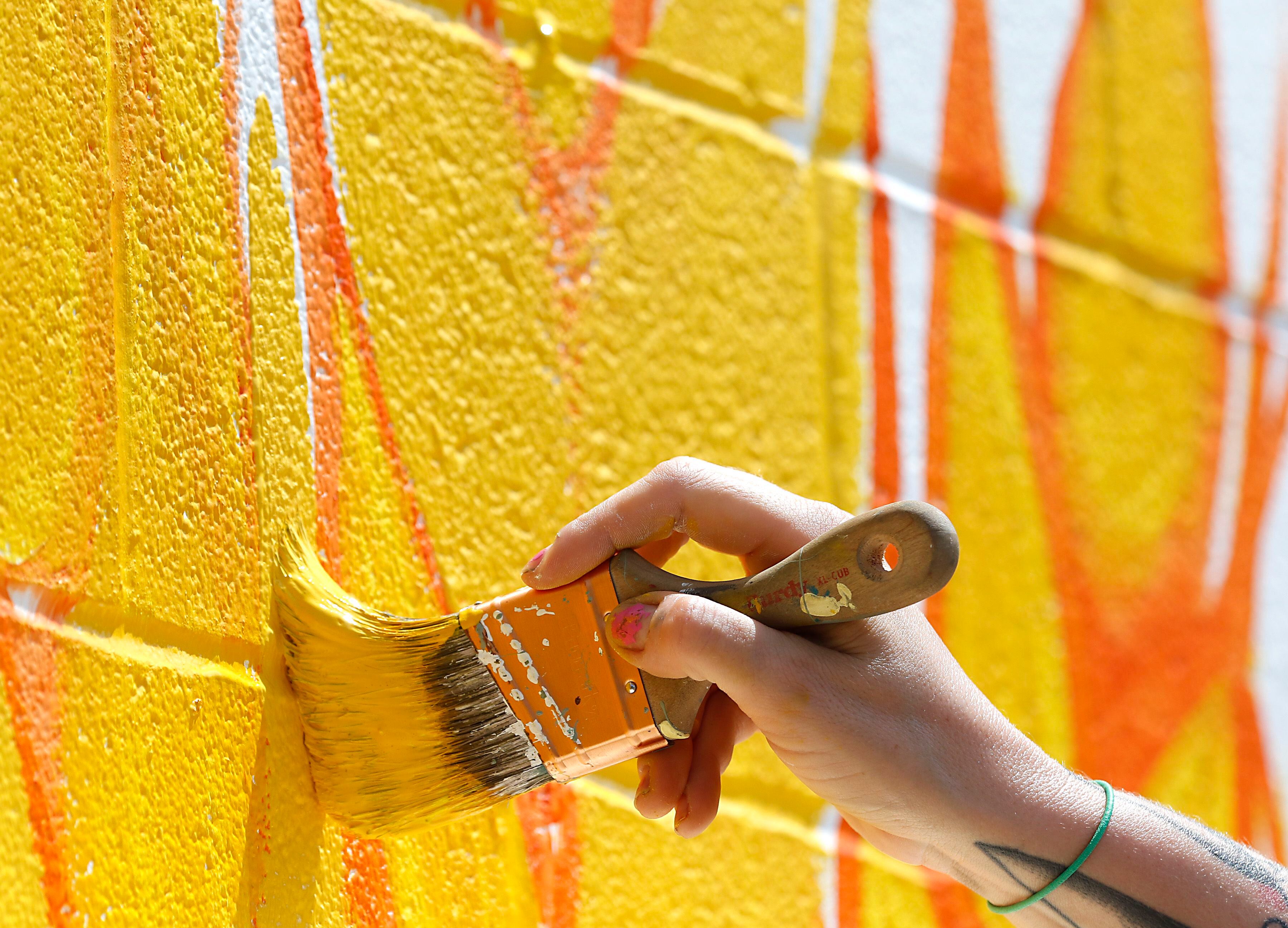 Melinda Cook paints mural on Thursday, June 19, 2025, on the side of the McHenry Brewing Co., in McHenry. This is one of two new McHenry murals in McHenry. 