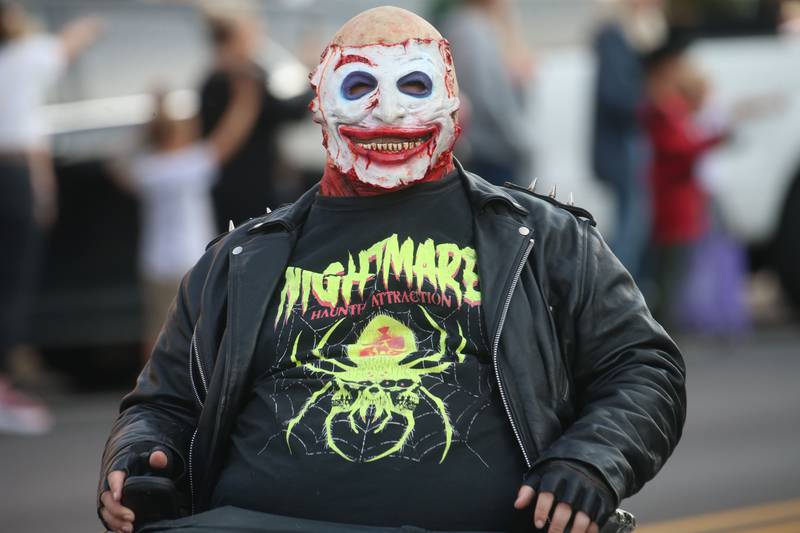 A character from the Nightmare on Fairgrounds Road Haunted Attraction rides in a mobile chair during the 6th annual Halloween parade on Saturday, Oct. 12, 2024 downtown Princeton.