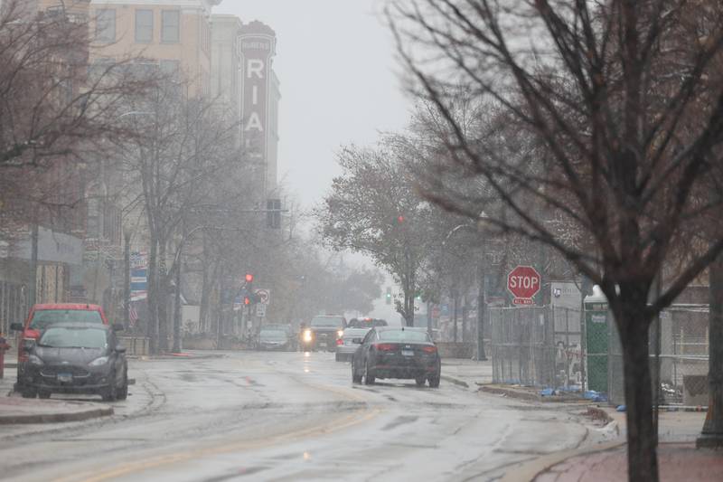 Snow comes down along North Chicago Street in downtown Joliet on Tuesday. The National Weather Service issued a Winter Weather Advisory from Tuesday until early Wednesday with snow accumulations of 1 to 3 inches expected throughout Will County.