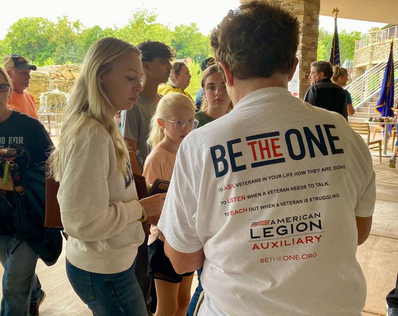 An organizer with the DeKalb American Legion Post No. 66 and American Legion Auxiliary helps get participants settled for the inaugural Be the One Walk to combat veteran suicide rates. The event kicked off at Northwestern Medicine Health and Wellness Center in DeKalb on Sunday, Sept. 22, 2024.
