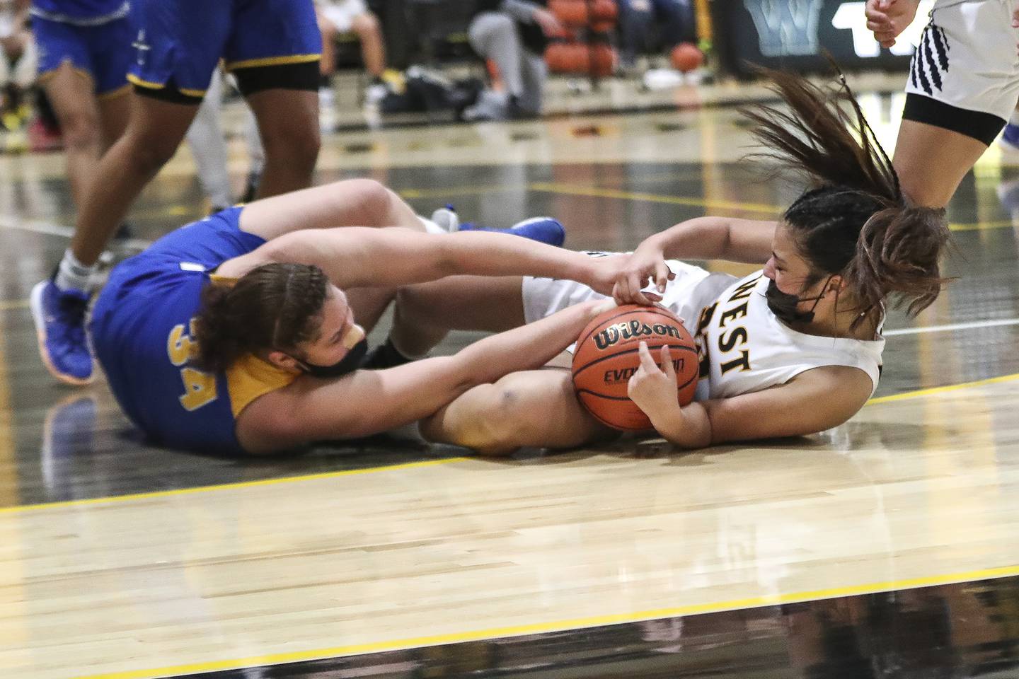 Joliet West's Miranda Rosales and Joliet Central's Nylah Davis battle over a loose ball on Tuesday, Feb. 16, 2021, at Joliet West High School in Joliet, Ill. The Tigers defeated the Steelmen 49-36.