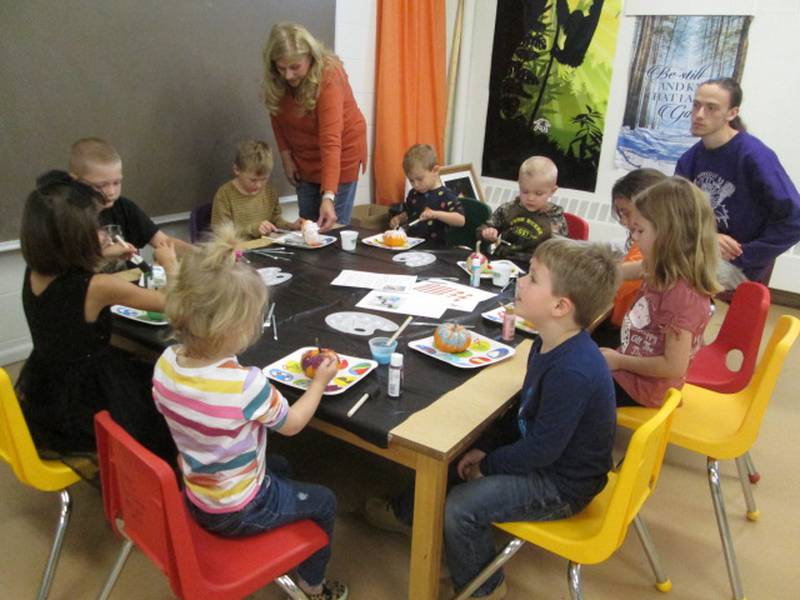 Pictured are children painting their pumpkins for their Halloween craft at Plano Methodist Church's Sunday School.