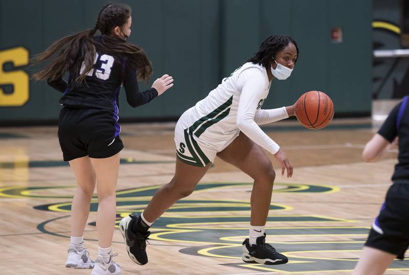 Crystal Lake South's Kree Nunnally brings the ball down the court past Hampshire's Lia Saunders during their game on Friday, January 14, 2022 at Crystal Lake South High School.