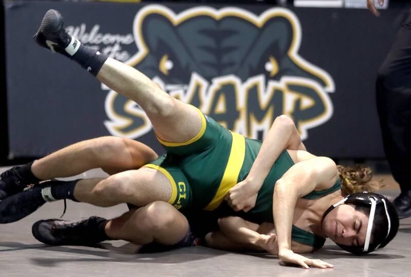 Crystal Lake South’s Leroy Flores, front, battles McHenry’s Pedro Jimenez in a 126-pound match during varsity wrestling at Crystal Lake Thursday night.