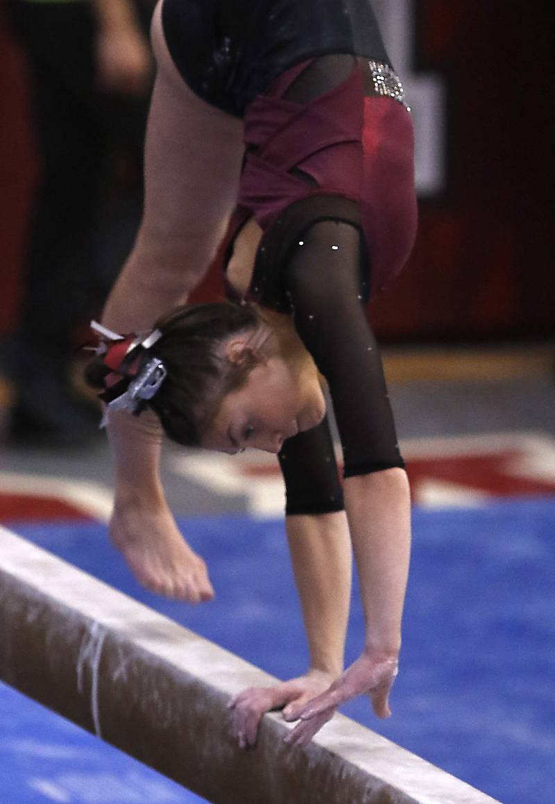 Prairie Ridge's Gabby Riley competes in the preliminary round of the balance beam Friday, Feb. 17, 2023, during the IHSA Girls State Final Gymnastics Meet at Palatine High School.