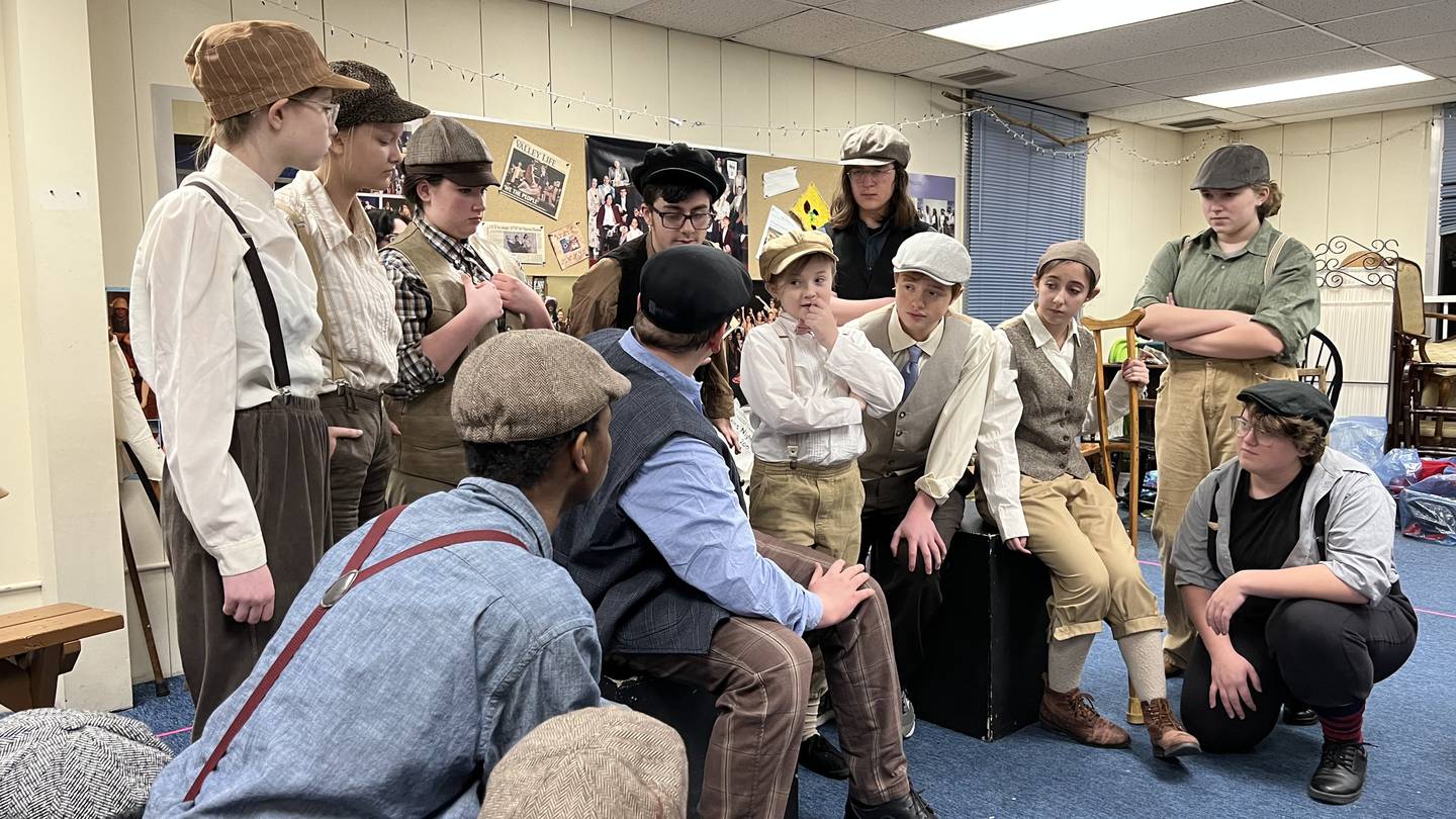 Child actors gather around during a Jan. 26, 2023 rehearsal for the Children's Community Theatre of DeKalb's production of the Disney, Broadway musical, Newsies.