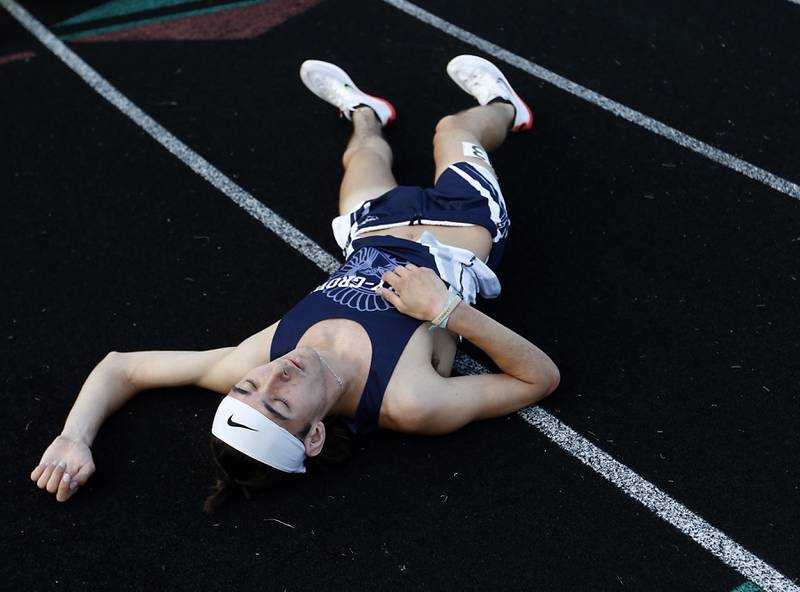 Cary-Groves Ian Barnes lays on the track after racing in the 3200 meter run during Fox Valley Conference boys track and field meet Friday, May 13, 2022, at Crystal Lake Central High School.