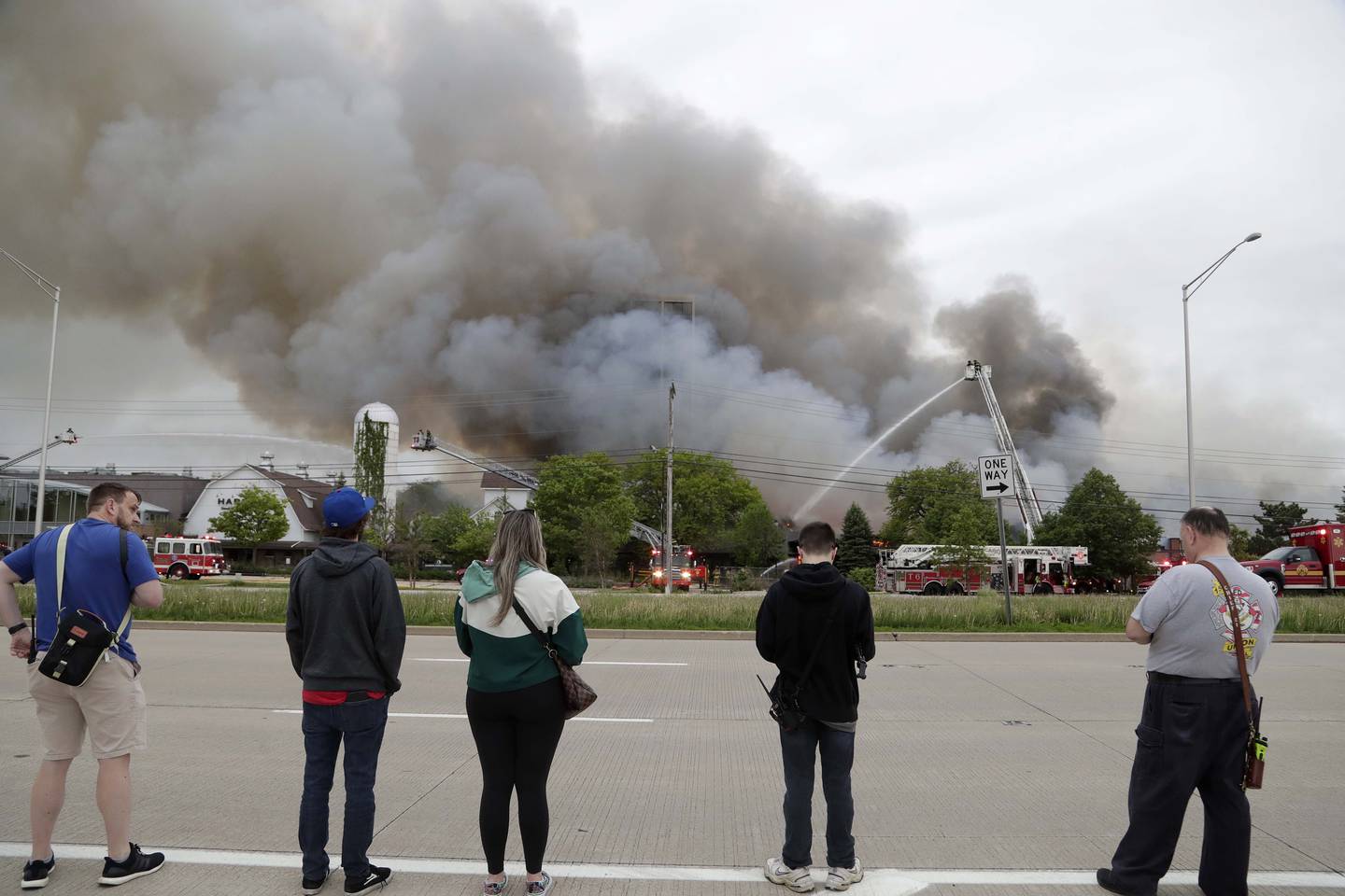 Onlookers watch as firefighters battle a blaze at the former Pheasant Run Resort on Saturday in St. Charles.