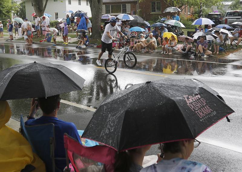 A bicyclists proms trick on Sunday, July 6, 2024, during Crystal Lake’s annual Independence Day Parade on Dole Avenue in Crystal Lake.