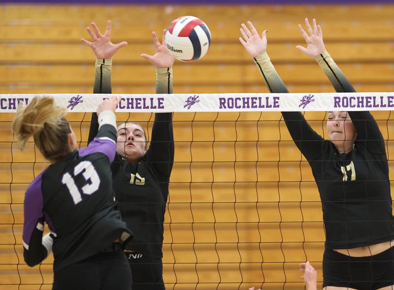 Sycamore's Isabella Culotta (left) and Laney Block try to block Dixon’s Solis Thompson Thursday, Oct. 30, 2025, during their Class 3A regional championship match in Rochelle.