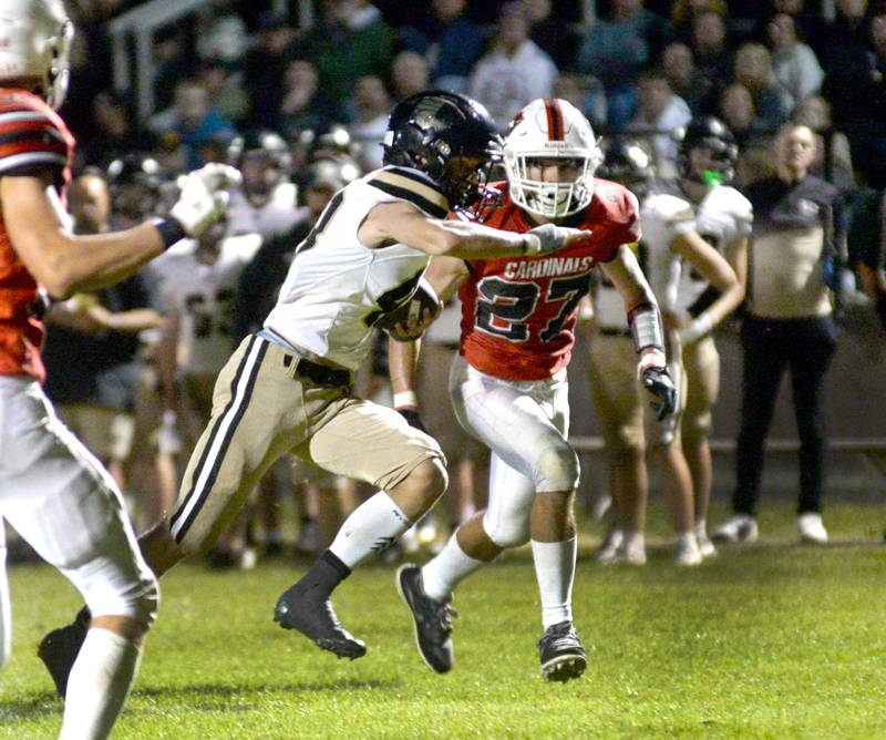 Lena-Winslow's Alec Schlichting runs for a gain as Forreston's Jonathan Milnes pursues on Friday, Aug, 29, 2025 at Forreston High School.